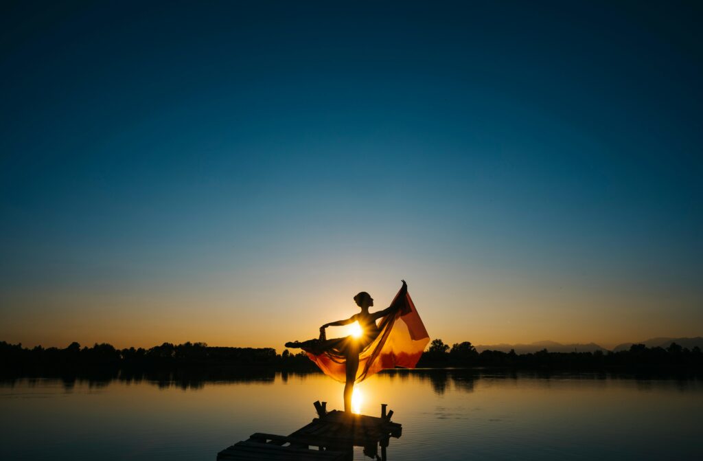 Woman Standing in Front of Body of Water Under Clear Blue Sky